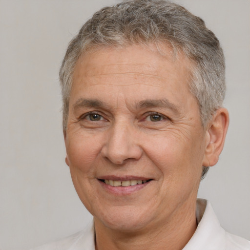 Joyful white middle-aged male with short  gray hair and brown eyes