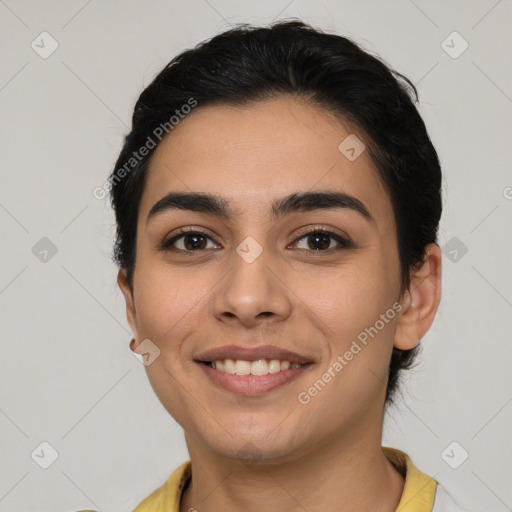 Joyful latino young-adult female with short  brown hair and brown eyes