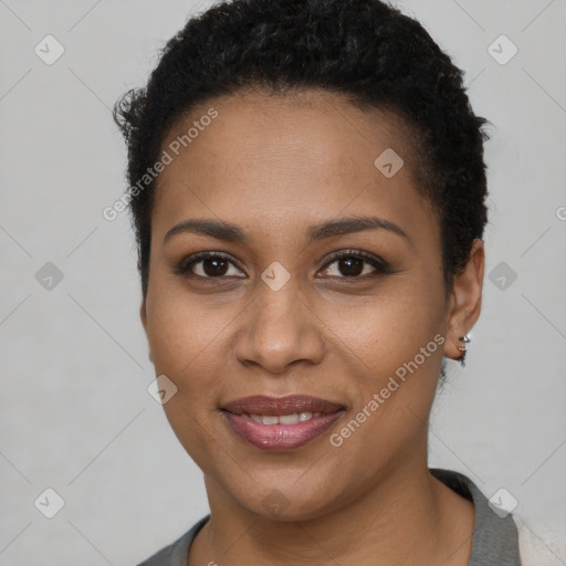 Joyful black young-adult female with short  brown hair and brown eyes