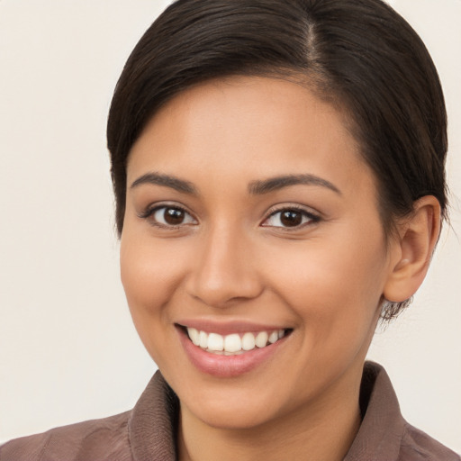 Joyful white young-adult female with long  brown hair and brown eyes