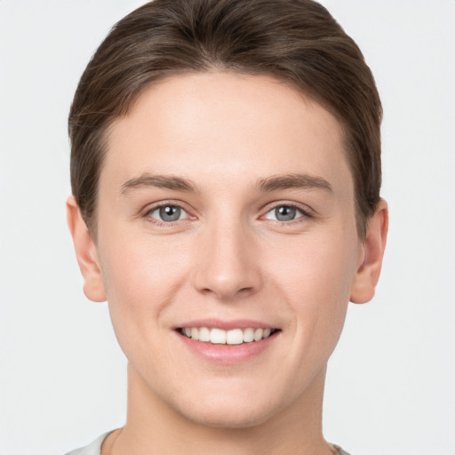 Joyful white young-adult female with short  brown hair and grey eyes