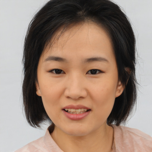 Joyful asian child female with medium  brown hair and brown eyes
