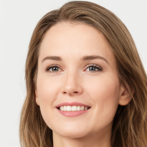 Joyful white young-adult female with long  brown hair and green eyes