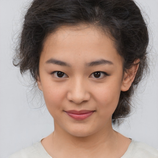 Joyful asian child female with medium  brown hair and brown eyes