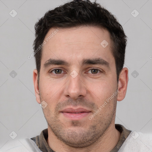 Joyful white adult male with short  brown hair and brown eyes