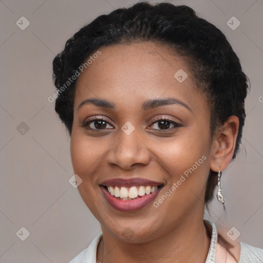 Joyful black young-adult female with short  brown hair and brown eyes