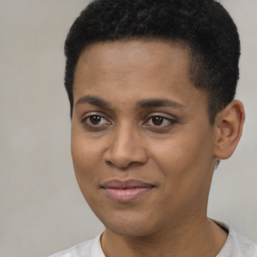 Joyful black young-adult female with short  black hair and brown eyes