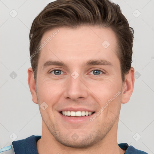 Joyful white young-adult male with short  brown hair and grey eyes