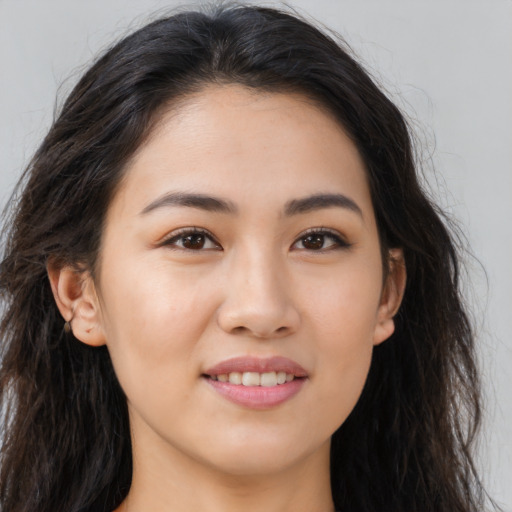 Joyful asian young-adult female with long  brown hair and brown eyes
