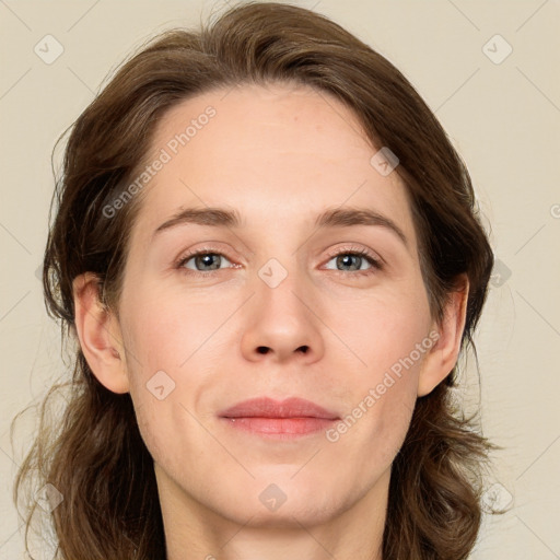 Joyful white adult female with medium  brown hair and green eyes