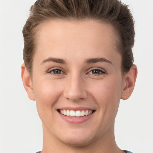 Joyful white young-adult female with short  brown hair and grey eyes