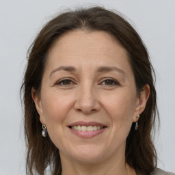 Joyful white adult female with medium  brown hair and grey eyes