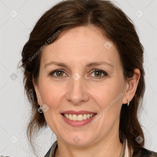 Joyful white adult female with medium  brown hair and green eyes