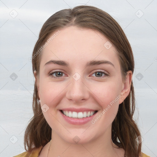 Joyful white young-adult female with medium  brown hair and blue eyes