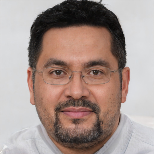 Joyful asian adult male with short  brown hair and brown eyes