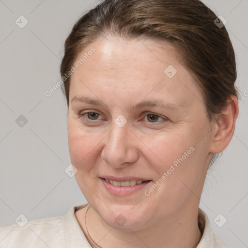 Joyful white adult female with medium  brown hair and grey eyes