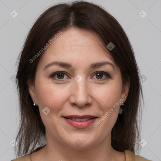 Joyful white adult female with medium  brown hair and brown eyes