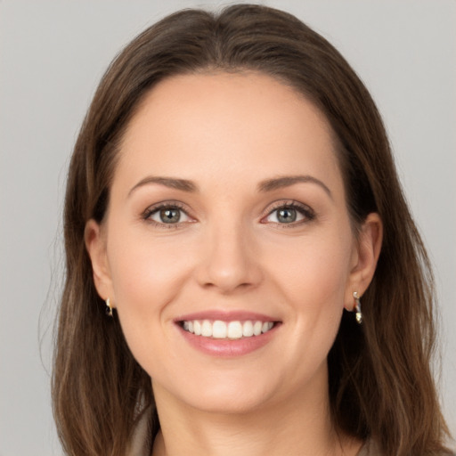 Joyful white young-adult female with long  brown hair and green eyes