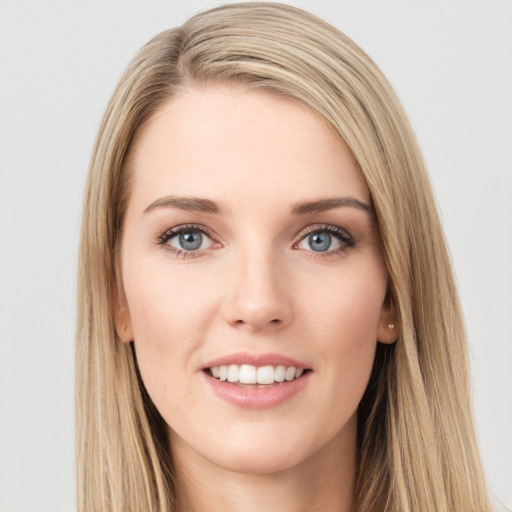 Joyful white young-adult female with long  brown hair and blue eyes