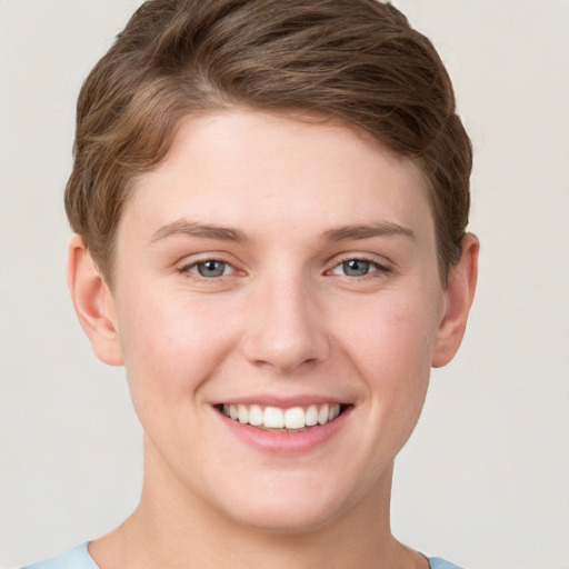 Joyful white young-adult female with short  brown hair and grey eyes