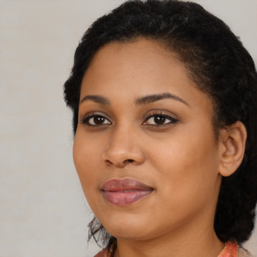 Joyful black young-adult female with medium  black hair and brown eyes