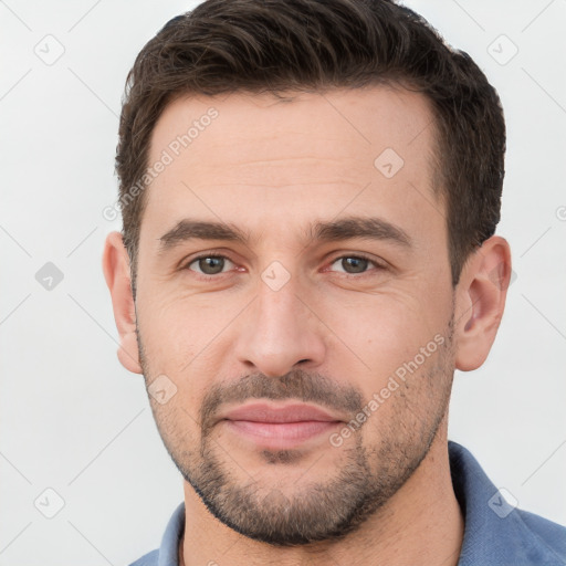 Joyful white young-adult male with short  brown hair and brown eyes