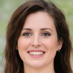 Joyful white young-adult female with long  brown hair and green eyes