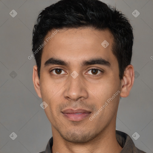 Joyful latino young-adult male with short  black hair and brown eyes