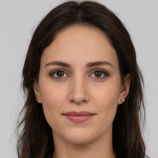 Joyful white young-adult female with long  brown hair and brown eyes