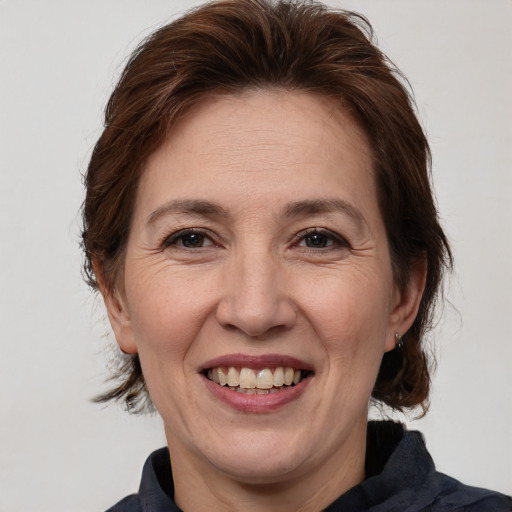 Joyful white adult female with medium  brown hair and brown eyes