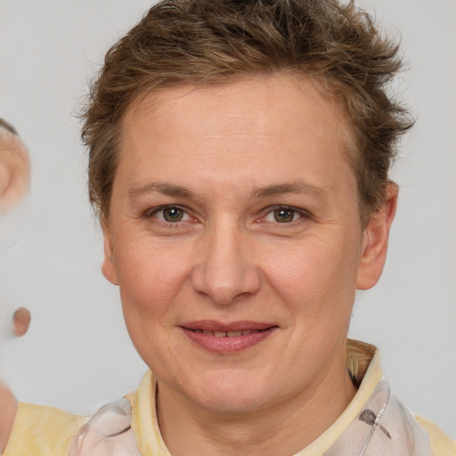 Joyful white adult female with short  brown hair and brown eyes