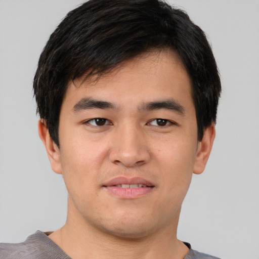 Joyful asian young-adult male with short  black hair and brown eyes