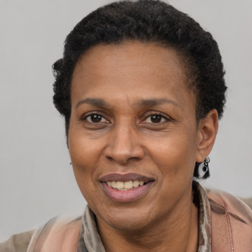 Joyful latino adult female with short  brown hair and brown eyes