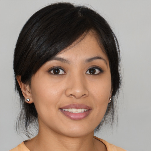 Joyful asian young-adult female with medium  brown hair and brown eyes