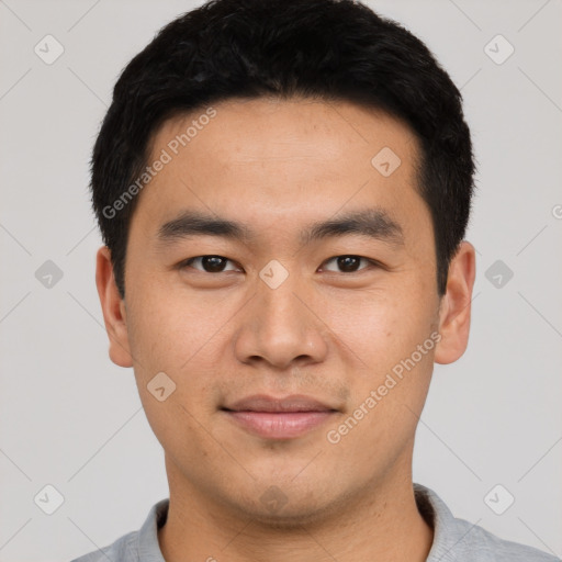 Joyful asian young-adult male with short  black hair and brown eyes