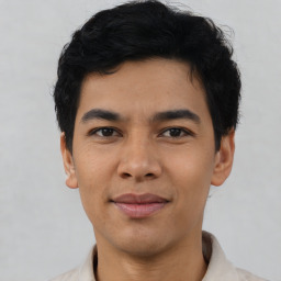 Joyful asian young-adult male with short  black hair and brown eyes