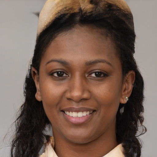 Joyful black young-adult female with medium  brown hair and brown eyes