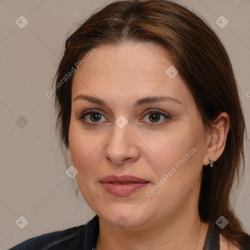 Joyful white adult female with medium  brown hair and brown eyes