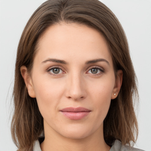 Joyful white young-adult female with long  brown hair and grey eyes