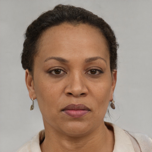 Joyful latino adult female with short  brown hair and brown eyes