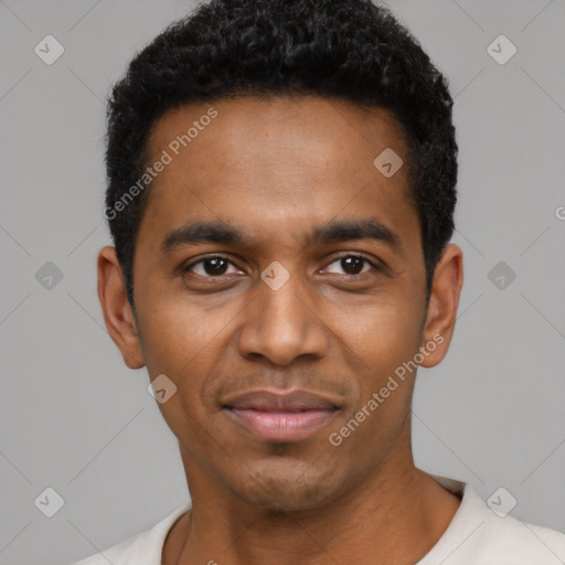 Joyful black young-adult male with short  black hair and brown eyes