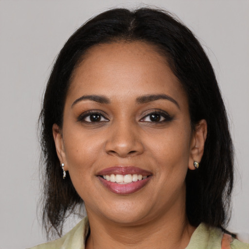 Joyful black young-adult female with medium  brown hair and brown eyes
