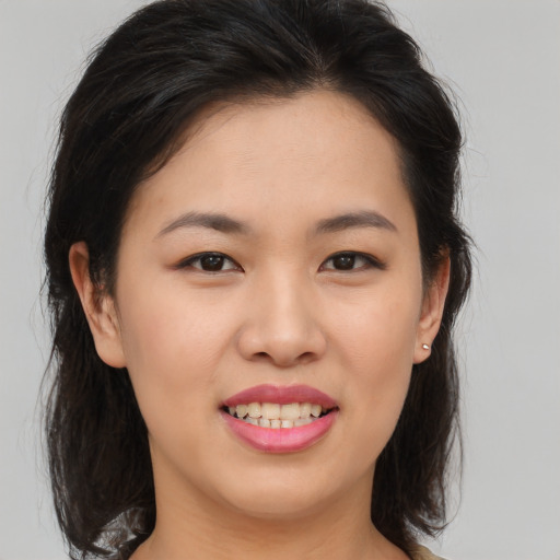 Joyful asian young-adult female with medium  brown hair and brown eyes