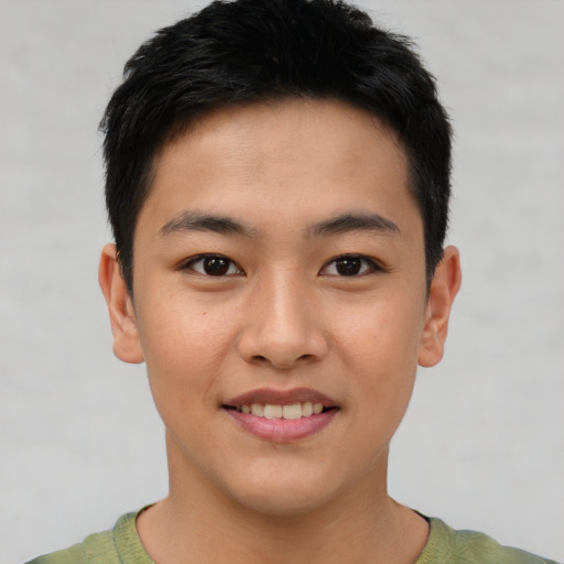 Joyful asian young-adult male with short  brown hair and brown eyes