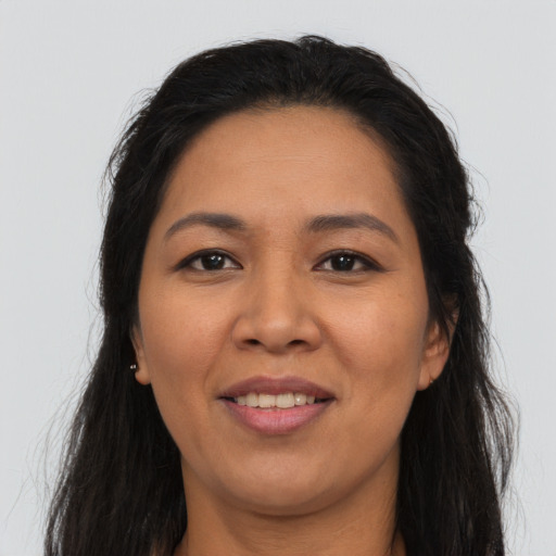 Joyful asian young-adult female with long  brown hair and brown eyes
