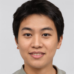 Joyful asian young-adult male with short  brown hair and brown eyes