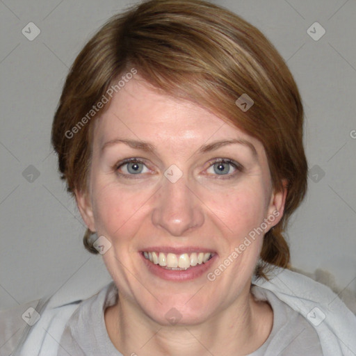 Joyful white adult female with medium  brown hair and blue eyes