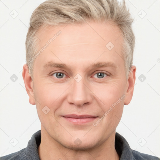 Joyful white adult male with short  brown hair and grey eyes