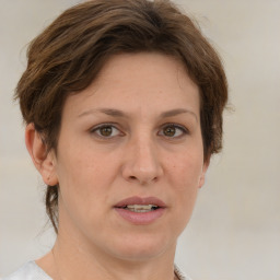 Joyful white adult female with medium  brown hair and grey eyes