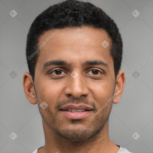 Joyful black young-adult male with short  brown hair and brown eyes